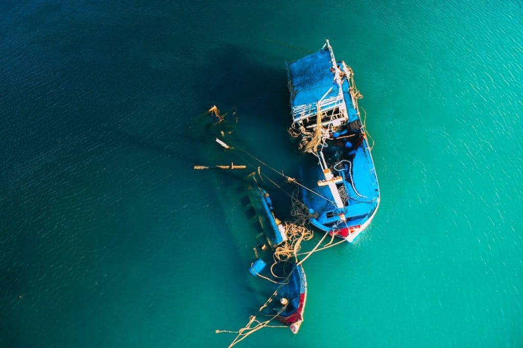 a couple of boats floating on top of a body of water.